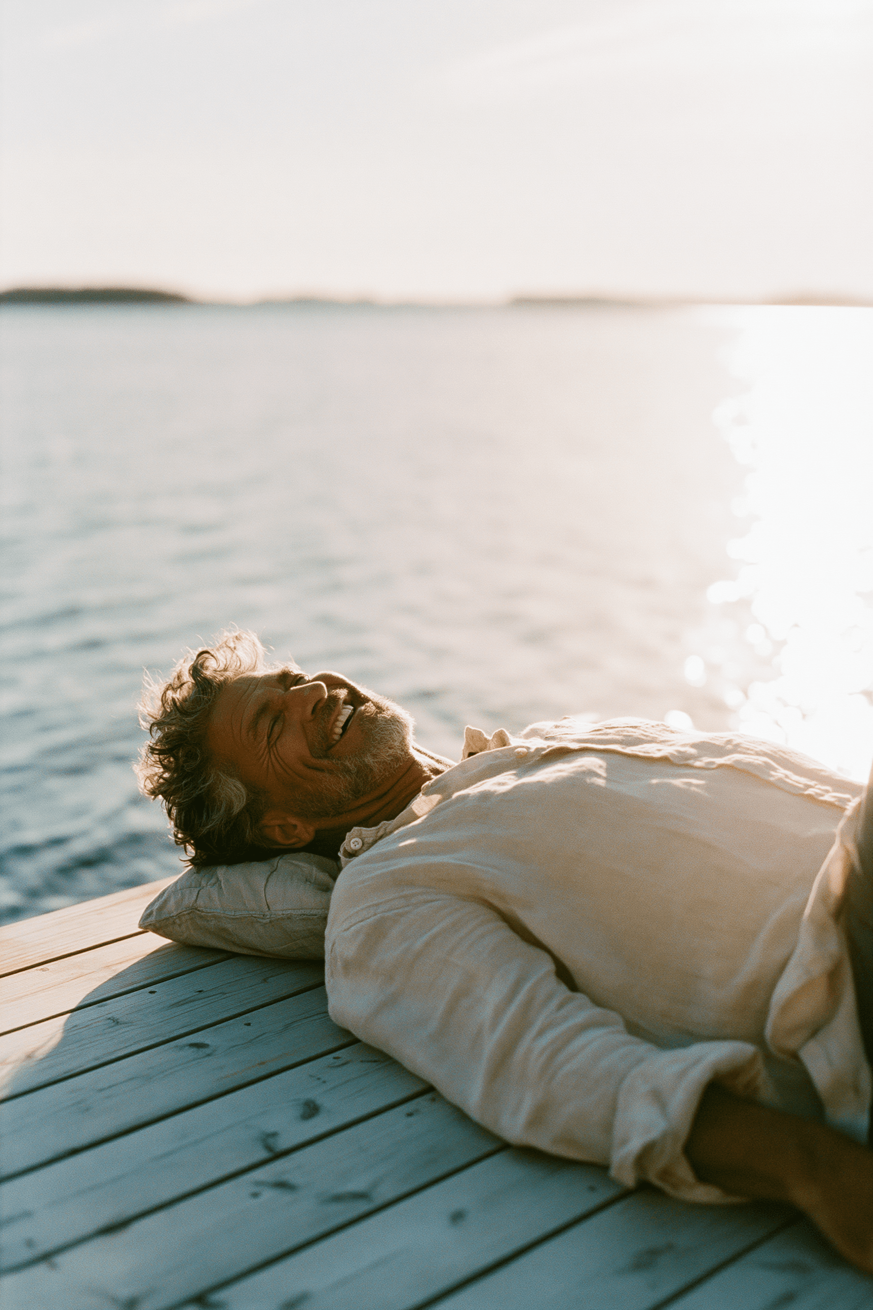 Teledris patient relaxing on a wooden dock by a sparkling lake